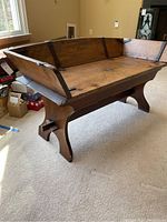 Front left view of wooden wagon seat coffee table