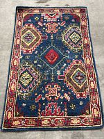 Front view of Blue Safavieh Heritage area rug, showing colorful traditional patterns on blue background