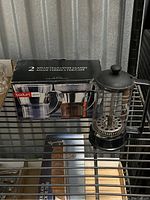 Two Bodum Assam glass tea mugs in original boxed packaging, box labeled in English and French.