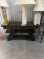 Full view of dark wood table bench showing sturdy A-frame legs and dark stained top surface.