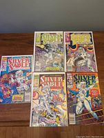 Five Silver Sable comics displayed on wooden surface, covers visible showing issues 2, 3, 6, 7, 8, all bagged and boarded