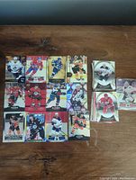 Top view of spread hockey cards showing various players and teams, cards feature different designs including red, white, and blue color schemes