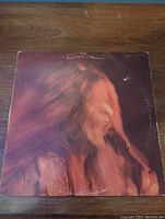 Front of Janis Joplin vinyl record album cover showing a blurred image of Janis Joplin singing into a microphone with visible wear on edges.