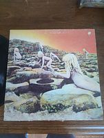 Front cover of the Houses of the Holy album with visible wear and damage on edges and upper right corner.