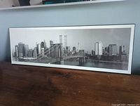 Full panoramic view of the Manhattan skyline with Brooklyn Bridge and Twin Towers, showing overall condition and size on pressboard.