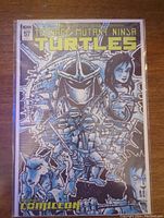 Front cover of Teenage Mutant Ninja Turtles comic book issue 57, featuring Shredder, a female character, and other series characters with detailed cover art.