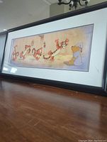 Wide angle photo of the framed Sericel featuring Tigger and Winnie the Pooh on wooden surface showing the artwork, frame, and plexiglass with minor crack