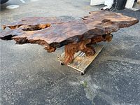 Side angled view showing the irregular live edge and driftwood base.