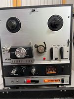 Front view showing large reel spindles, stereo field dial, Roberts 778X label, control knobs, meters, and switches.