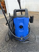 Front view of blue and black Simbr pressure washer with power cord coiled around body and control dial in front