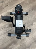 Top view of the Therapy Cycle pedal exerciser showing digital monitor and pedals with foot straps.