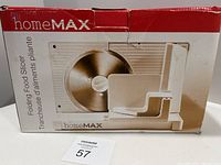 Photo of the original red and white homeMAX folding food slicer box showing the product image and branding.