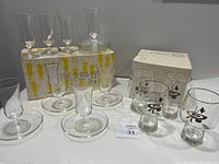 Full view of the parfait set on original box with 4 curling beer glasses in front, showing all items included and packaging.