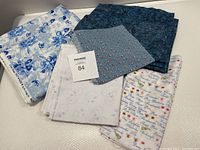 Top down view showing the five fabric pieces stacked loosely displaying pattern variety