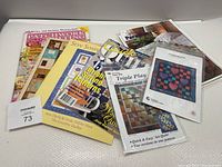 Overview of various quilting magazines and pattern booklets with colorful patchwork designs including instructions and quilting guides.