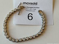 Full view of Dee Barkley sterling silver tennis bracelet with round CZ stones.