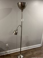 Full view of the floor lamp displaying the entire lamp including the base, pole, adjustable reading arm, and top bowl shade.