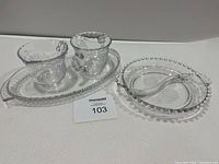 Full view of cream and sugar set on elongated tray with relish dish and divided insert beside