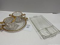 Photo showing Hazel Atlas snack, sip and smoke ball with ribbed tray, along with Jeanette Glass creamer, sugar, and bubble glass tray.