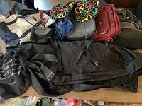 Overview photo showing all bags piled together including Sport Rack bag, Swiss Army backpack, Swiss Gear laptop bag, American Tourister bag, Gonex bag, and assorted totes.