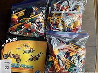 Three resealable bags containing assorted colorful plastic rods and connectors for Kinex Model Building Set 32 along with manual.