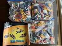 Three plastic bags filled with assorted Kinex construction parts and original booklet
