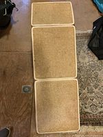 Top view showing the carpeted surface of the three connected sections of the ramp laid flat.