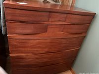 Front view of the dresser showing five curved-front drawers and overall profile