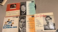Photo showing five assorted 45 RPM records featuring vintage opera and vocal performances by Boris Christoff, Ezio Pinza, and Jussi Björling with visible front covers and artist portraits.