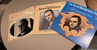 Photo shows three vinyl record covers featuring Beniamino Gigli with portraits and vintage design styles.