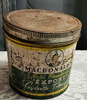 Front and rim view of vintage Macdonald's Gold Standard Export cigarette tobacco tin showing label and aged patina.