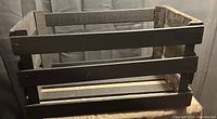 Single image of a wooden crate with slatted sides and solid bottom, displayed against a neutral background.