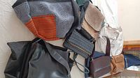 Overview of six assorted purses showing various materials, colors, and styles, including a Danier leather purse and a patterned cloth bag