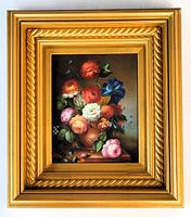 Front view of floral oil painting in ornate gold frame
