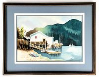 Front view of framed watercolour painting showing signed image of waterfront coastal scene with dock and boats, mountain background.
