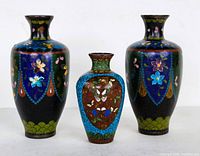 Front view of three Chinese cloisonne vases including pair and single