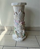 Full view of the handmade pottery column showing overall shape, texture, and colors.