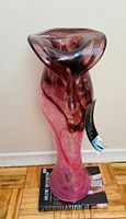 Photo of vintage handblown glass vase showing front and revealing pink and darker swirl colors.