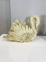 Side view of swan planter showing feather detail and curved neck.