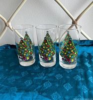 Front view of the three highball glasses showing Christmas tree design.