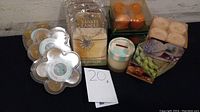 Multiple candle packs including tea lights, a jar candle, and a sealed Yankee Candle Jar Jewelry package.