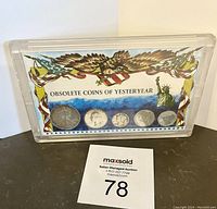 Front and full lot view showing the coins encased with patriotic design and Statue of Liberty image.