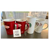 Four branded coffee mugs from Tim Hortons and Starbucks displayed on a counter without visible damage.