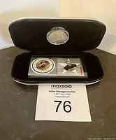 Black display case holding the NHL commemorative coin and stamps, closed with a transparent cover.
