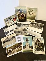 Overview of 14 postcards, a mix of color and black and white, showing northern Ontario and cottage country scenes including landscapes, streets, nature, and monuments.