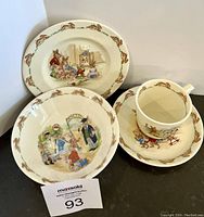 Full view of Royal Doulton Bunnykins dinner plate, bowl, cup, and saucer arranged for display.