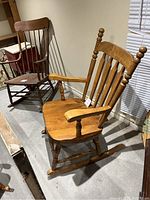 Side view of vintage rocking chair showing solid pine construction and detail of spindles and armrests.