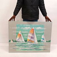 Front view of the signed original sailboat painting held by person illustrating size and colors.