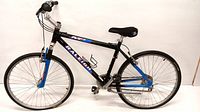 Full side view of Raleigh M50 men's mountain bike showing black and blue frame, tires, pedals, and saddle.