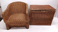 Full view of the vintage woven wicker armchair and matching storage chest side by side on a white background.